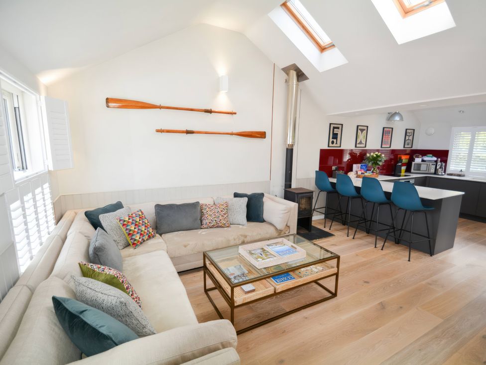 A living room with a sofa and kitchen island at Port House in Lyme Regis
