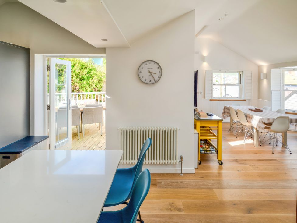 A kitchen with a table and chairs at Port House in Lyme Regis