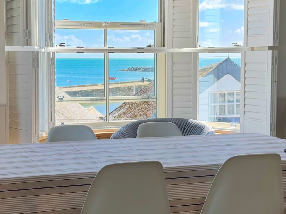 A dining room with a view of the sea at Port House in Lyme Regis