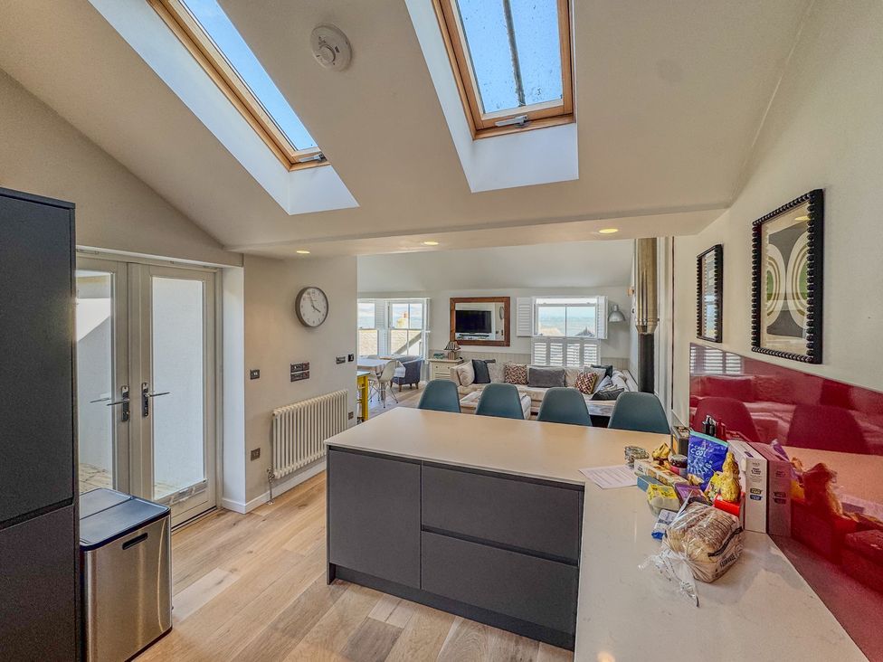 A kitchen with skylights and a dining area at Port House in Lyme Regis