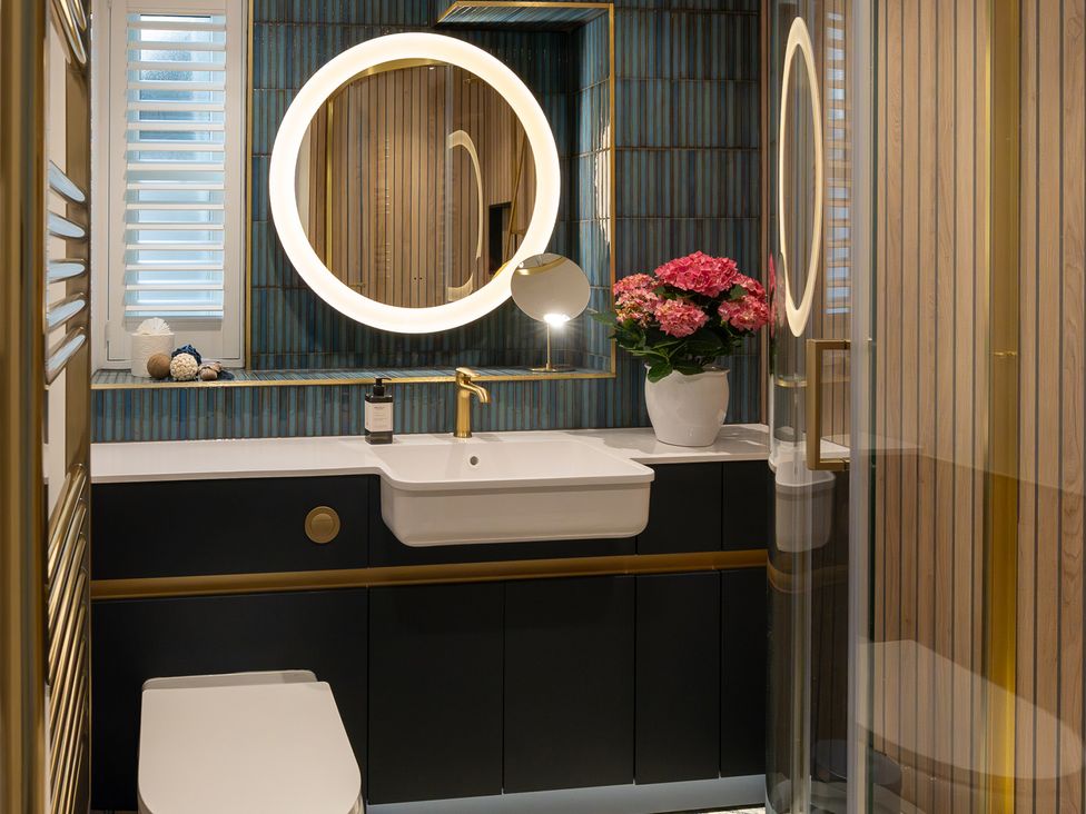 A bathroom with a sink and a mirror at Port House in Lyme Regis