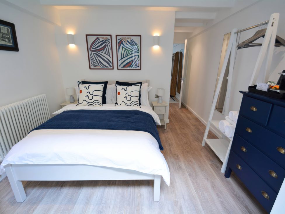 A bedroom with a bed and nightstand at Port House in Lyme Regis