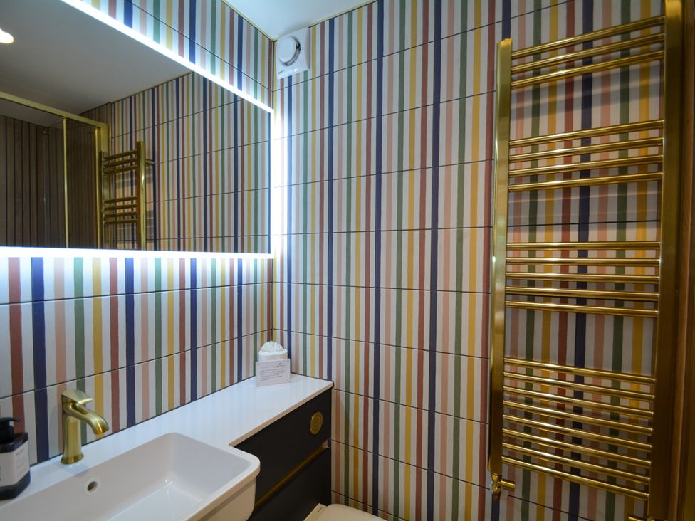 A bathroom with a sink and mirror at Port House in Lyme Regis