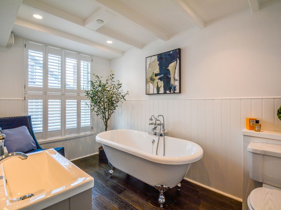 A bathroom with a free-standing bathtub and a toilet at Port House in Lyme Regis
