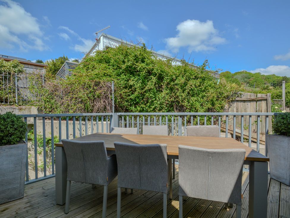 An outdoor dining area with a table and chairs at Port House in Lyme Regis