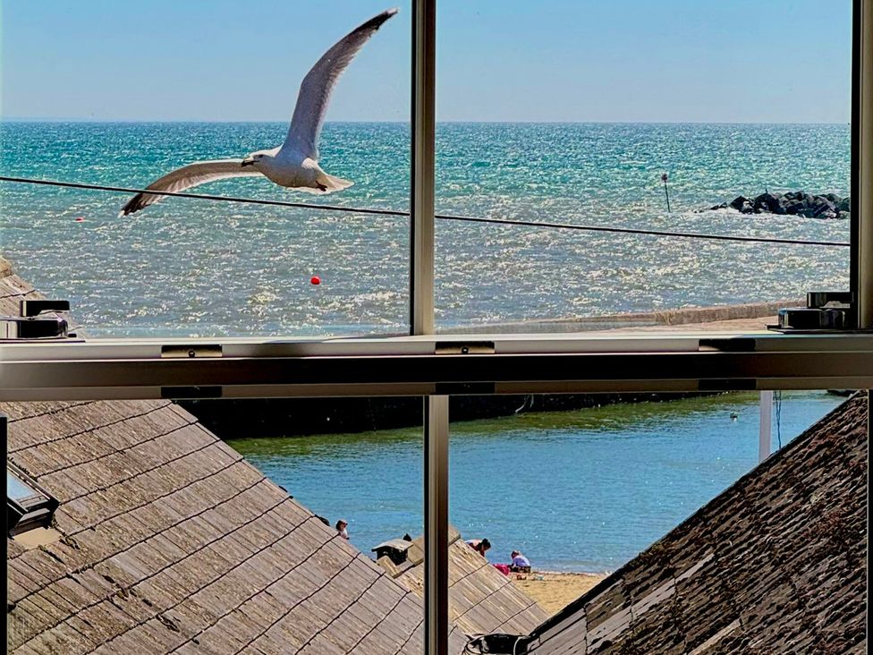 A view of the beach and sea from a window at Port House in Lyme Regis