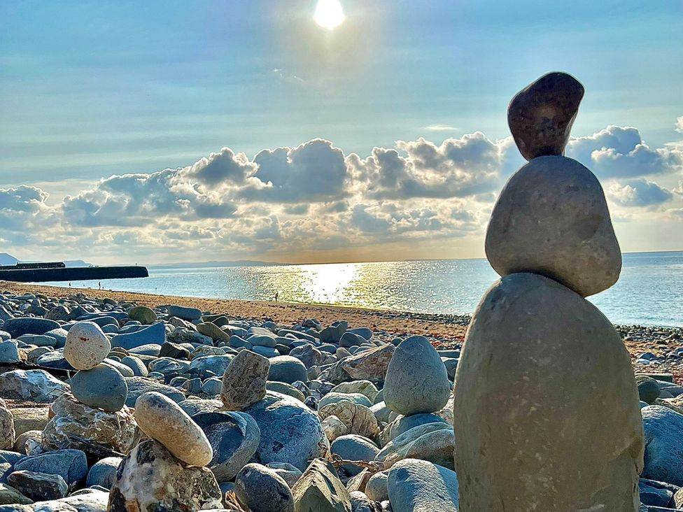 Rocks along the beach with the sea and sky at Port House Lyme Regis