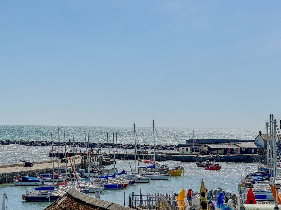 A harbor with numerous boats and yachts at Port House in Lyme Regis