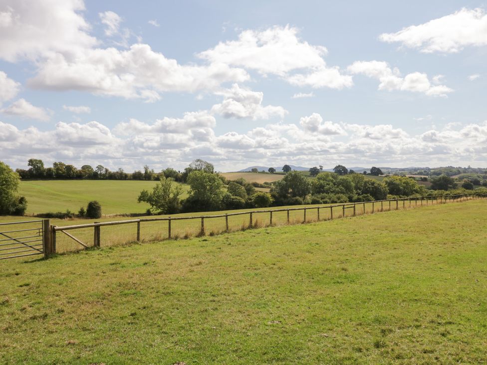 A field with a fence and gate at Keepers Barn in Bromyard
