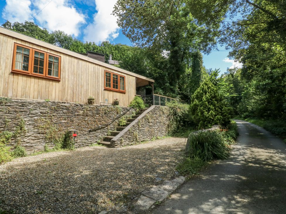 A wooden house with stone steps and a gravel pathway at Ty Barddu Cwmorgan near Newcastle Emlyn