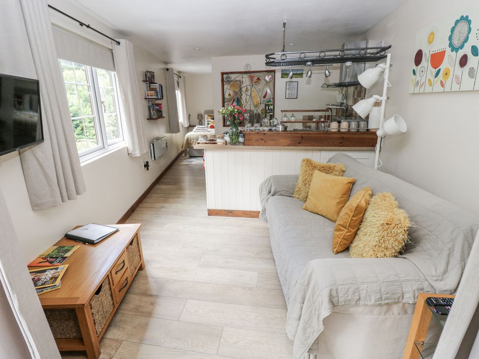 A living room with a sofa and television at Ty Barddu in Cwmorgan near Newcastle Emlyn