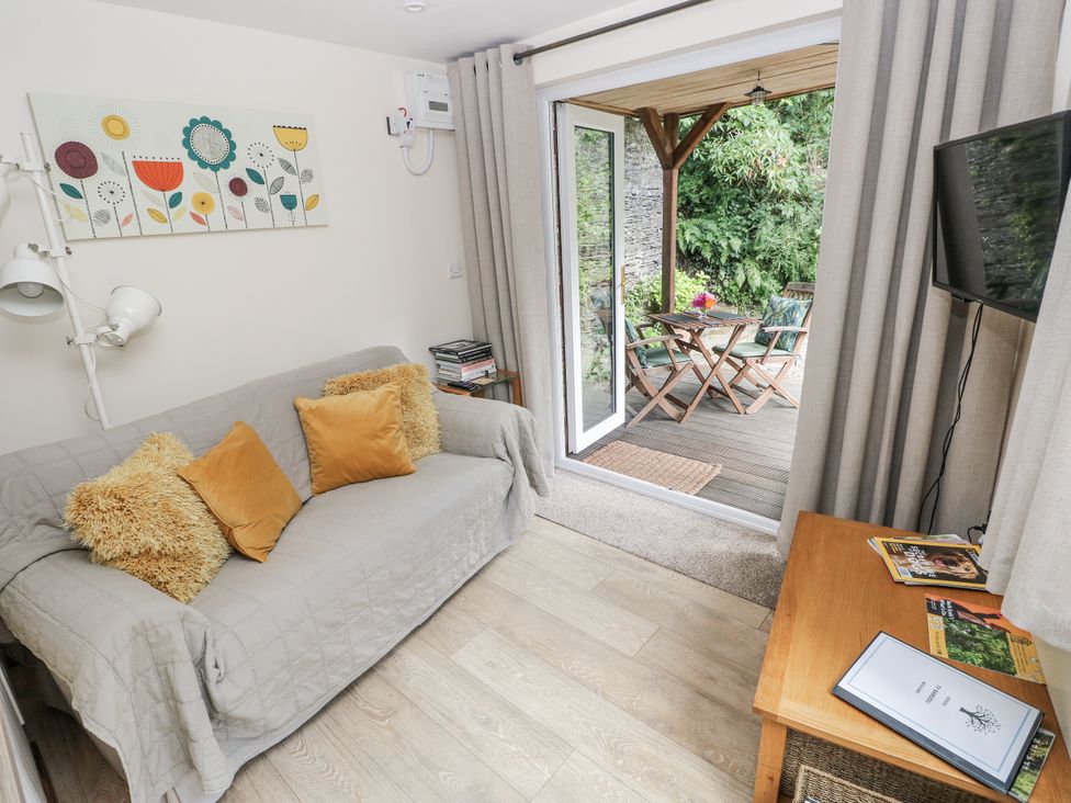 A living room with a sofa and television at Ty Barddu in Cwmorgan near Newcastle Emlyn