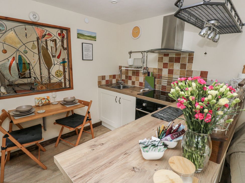 A kitchen with a table and chairs at Ty Barddu in Cwmorgan near Newcastle Emlyn