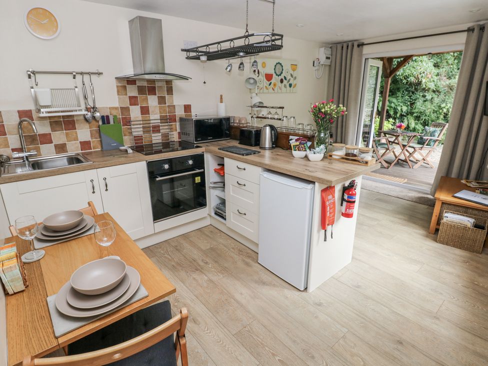 A kitchen with a table and chairs at Ty Barddu Cwmorgan near Newcastle Emlyn