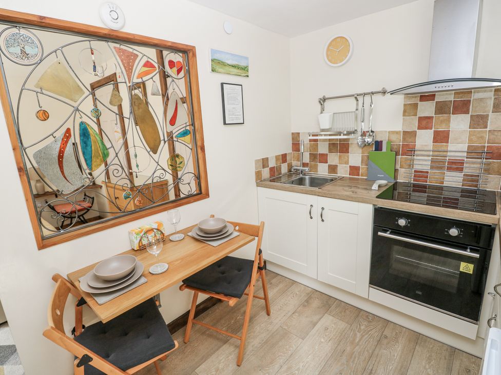 A kitchen with a table and chairs at Ty Barddu in Cwmorgan near Newcastle Emlyn