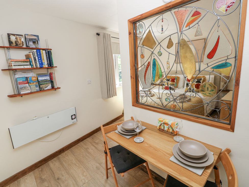 A dining room with a table and chairs at Ty Barddu in Cwmorgan near Newcastle Emlyn