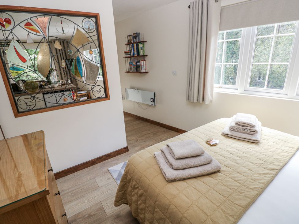A bedroom with a bed and towels at Ty Barddu in Cwmorgan near Newcastle Emlyn