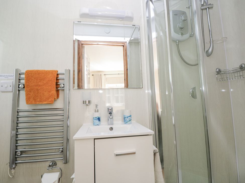 A bathroom with a shower and sink at Ty Barddu in Cwmorgan near Newcastle Emlyn
