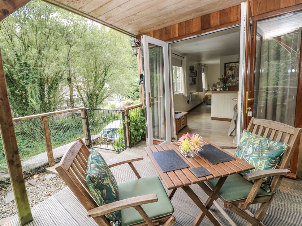 A patio area with a table and chairs at Ty Barddu near Cwmorgan