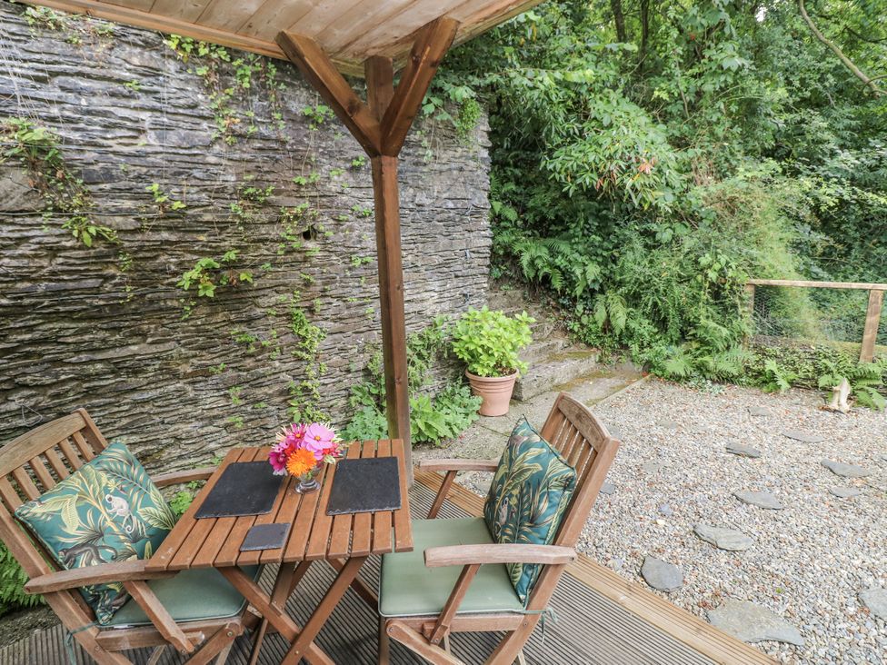 An outdoor seating area with a table and chairs at Ty Barddu in Cwmorgan near Newcastle Emlyn