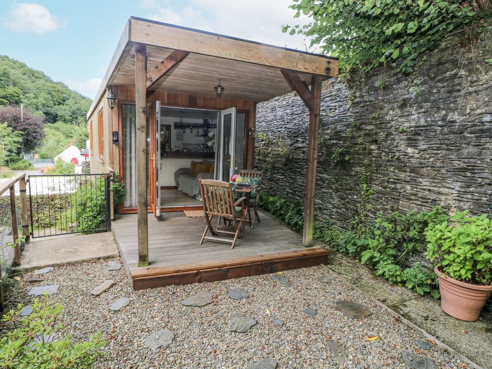 An outdoor seating area with a table and chairs at Ty Barddu Cwmorgan near Newcastle Emlyn