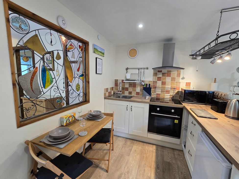 A kitchen with a table and chairs at Ty Barddu Cwmorgan near Newcastle Emlyn