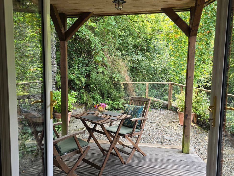 An outdoor seating area with table and chairs at Ty Barddu Cwmorgan near Newcastle Emlyn