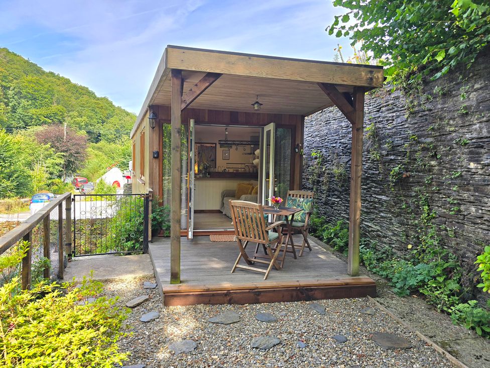 An outdoor seating area with table and chairs at Ty Barddu in Cwmorgan near Newcastle Emlyn