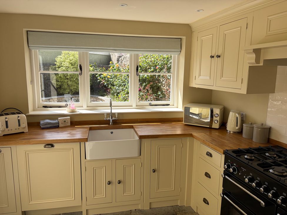 A kitchen with a sink and appliances at Malabar House in Lyme Regis