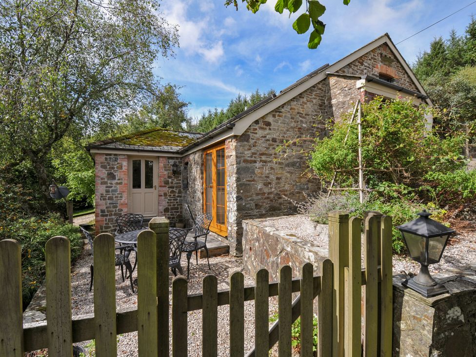 An outdoor area with a table and chairs at Shipload Cottage in Hartland