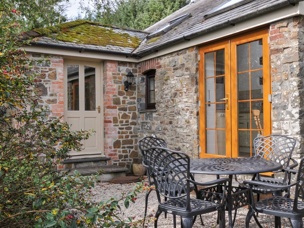 An outdoor area with a table and chairs at Shipload Cottage in Hartland
