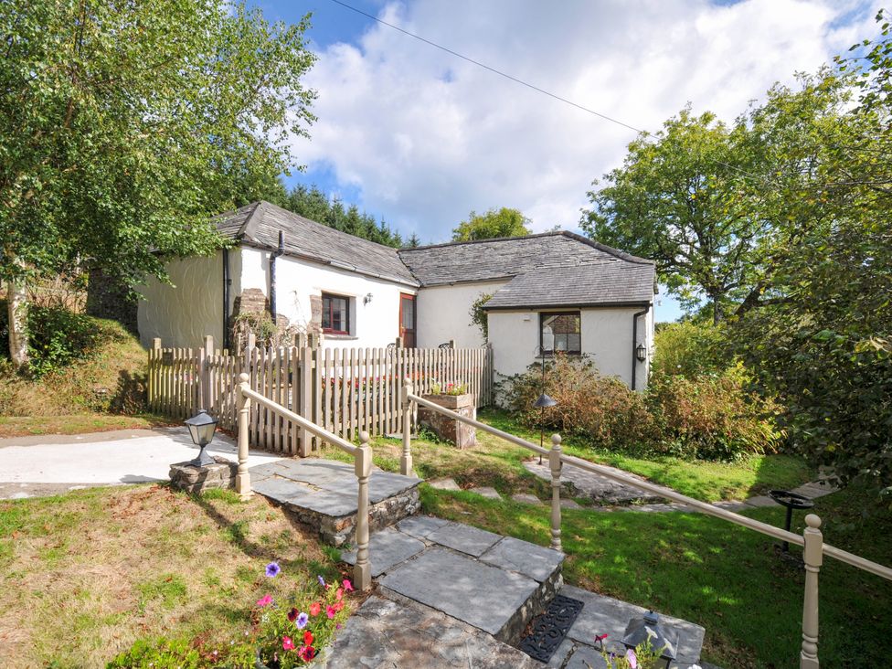 An exterior view of a house with a fence and steps at Windbury Cottage in Hartland