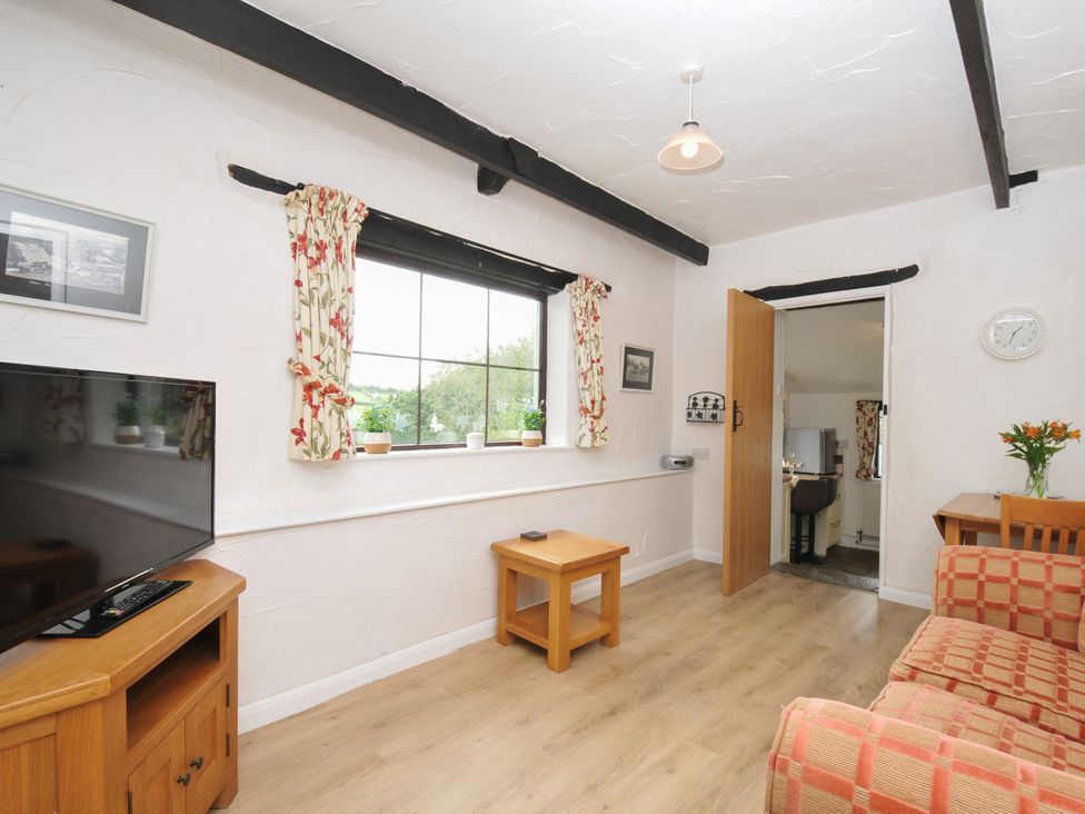 A living room with a sofa and television at Barley Cottage in Hartland