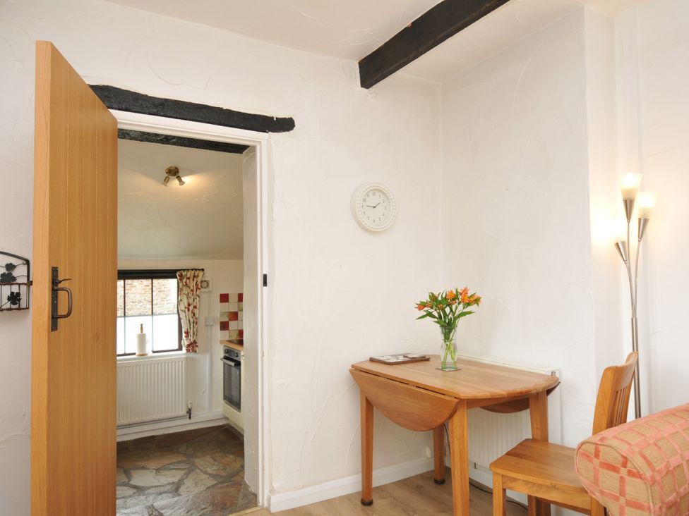 A dining area with a table and chairs at Barley Cottage in Hartland