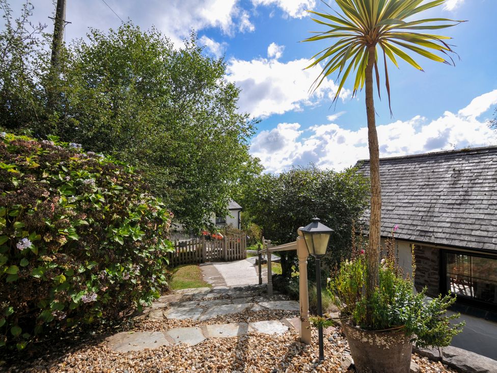 An outdoor pathway with stones and plants at Barley Cottage in Hartland