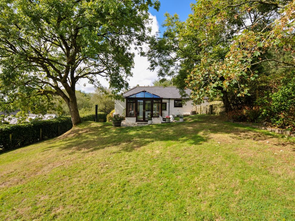 A house with a garden and trees at Barley Cottage in Hartland