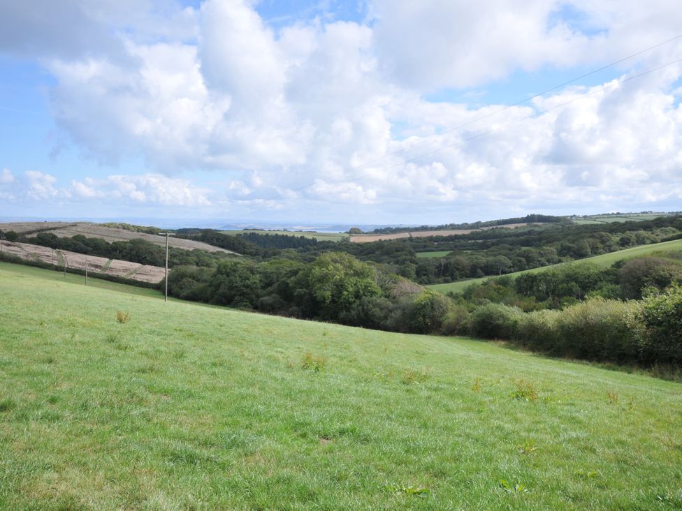 A landscape view of hills and trees at Barley Cottage in Hartland