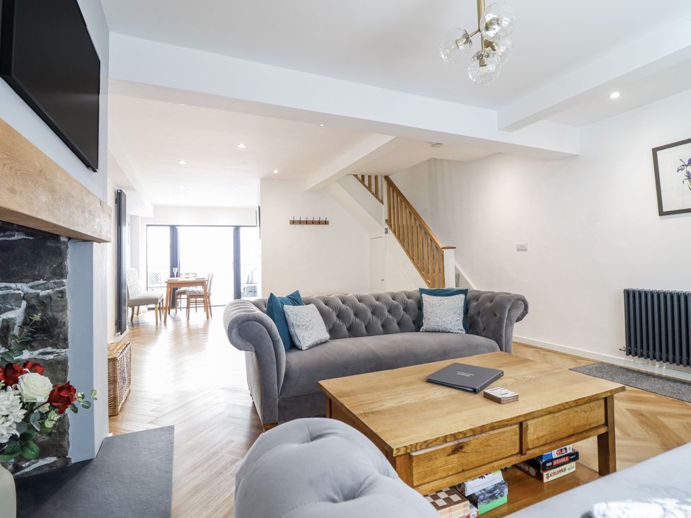 A living room with a sofa and coffee table at Neptune Cottage in Conwy