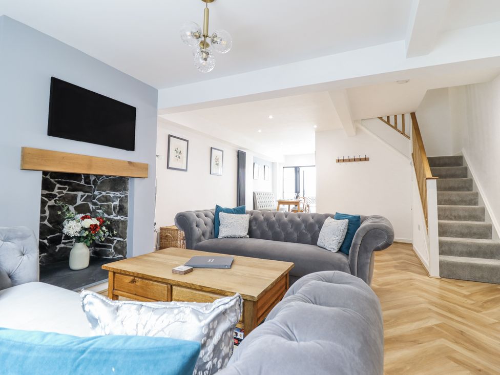 A living room with a sofa and coffee table at Neptune Cottage in Conwy