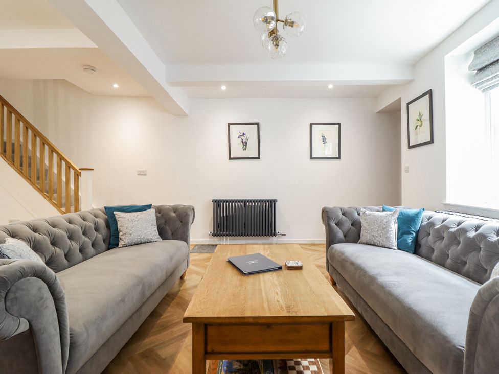 A living room with sofas and a coffee table at Neptune Cottage in Conwy