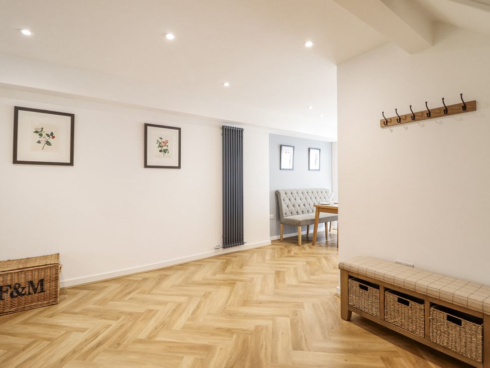 A dining room with a table and chairs at Neptune Cottage in Conwy