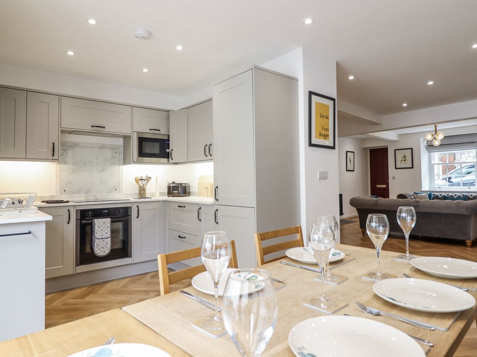 A kitchen with dining table and chairs at Neptune Cottage in Conwy