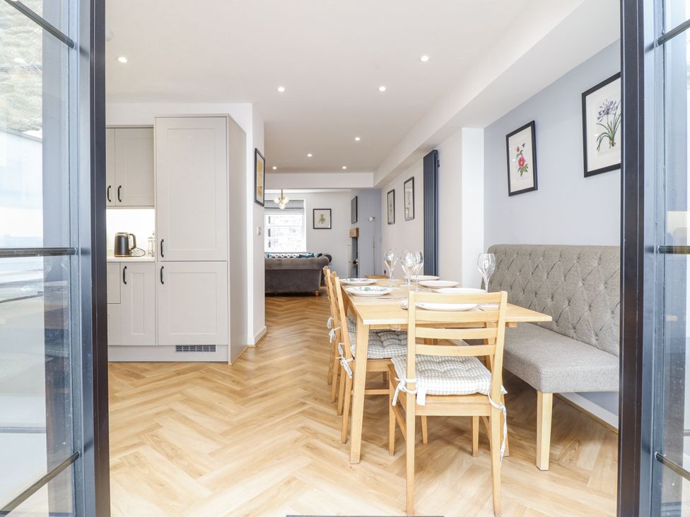 A dining area with chairs and a table at Neptune Cottage in Conwy