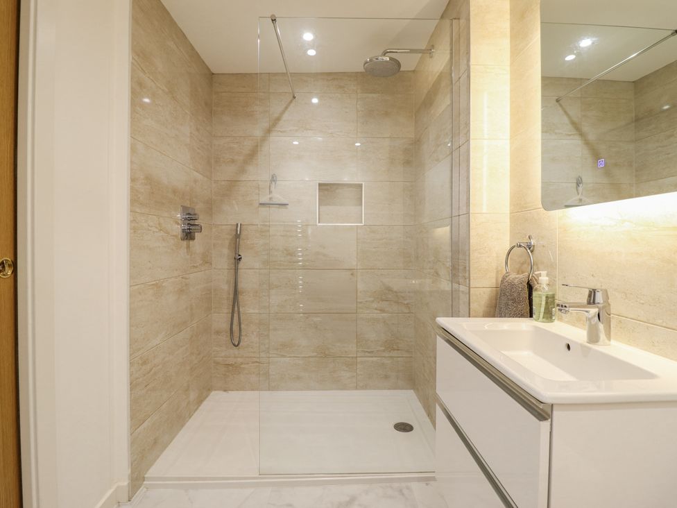 A bathroom with a shower and a sink at Neptune Cottage in Conwy