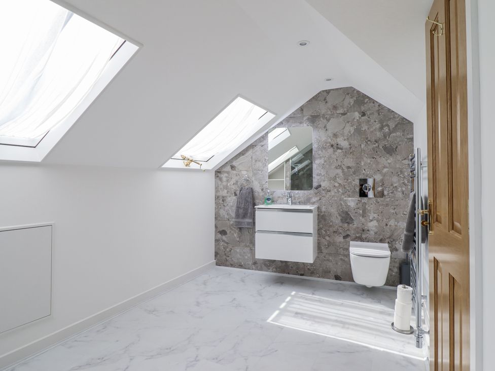 A bathroom with skylights and a vanity at Neptune Cottage in Conwy