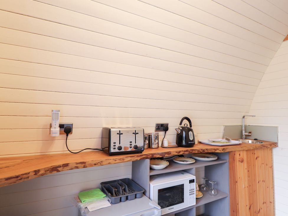 A kitchen with appliances and dishes at Pod 2 in Beauly