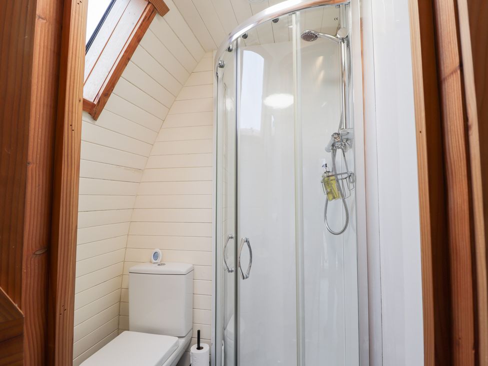 A bathroom with a shower and toilet at Pod 2 Beauly
