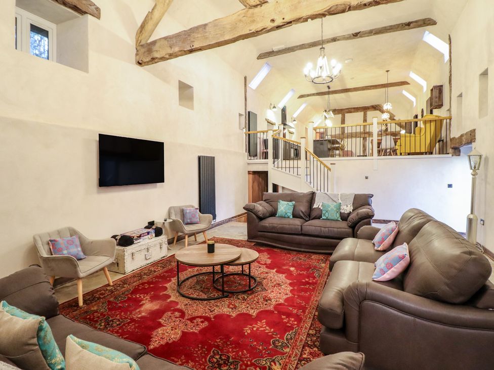 A living room with sofas and a coffee table at Godre'r Gyrn, Plas Moelfre Hall Barns in Oswestry
