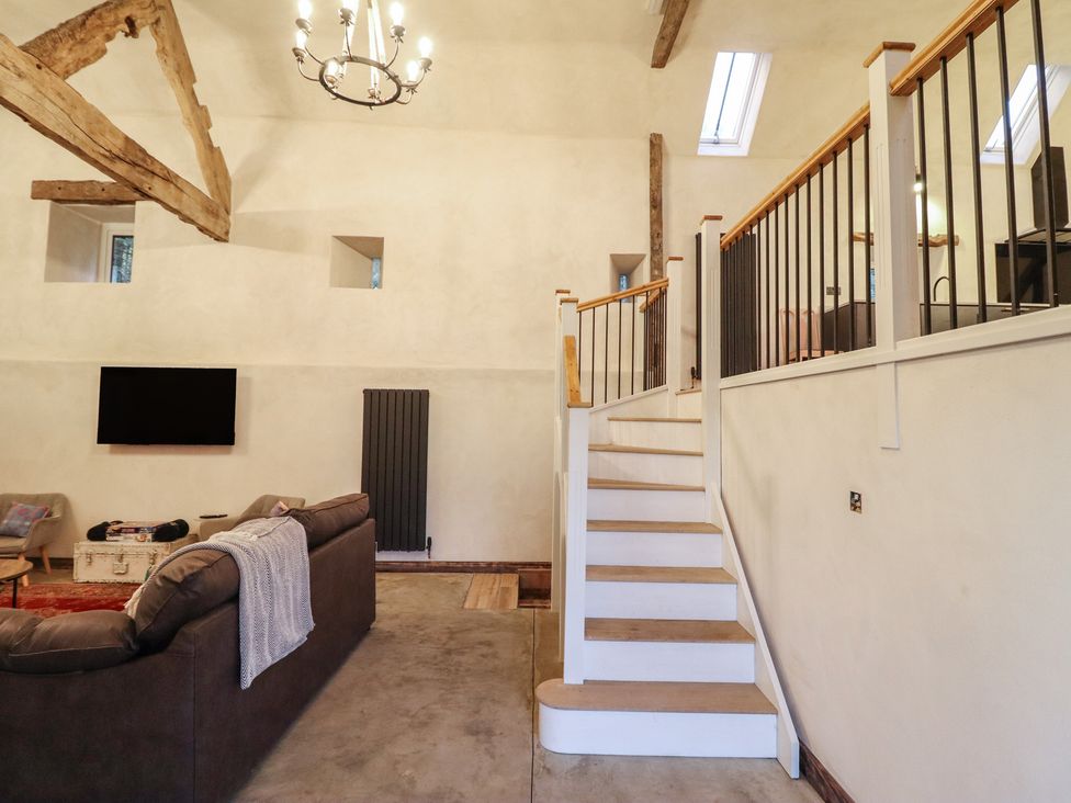 A living room with a sofa and television at Godre'r Gyrn, Plas Moelfre Hall Barns, Oswestry