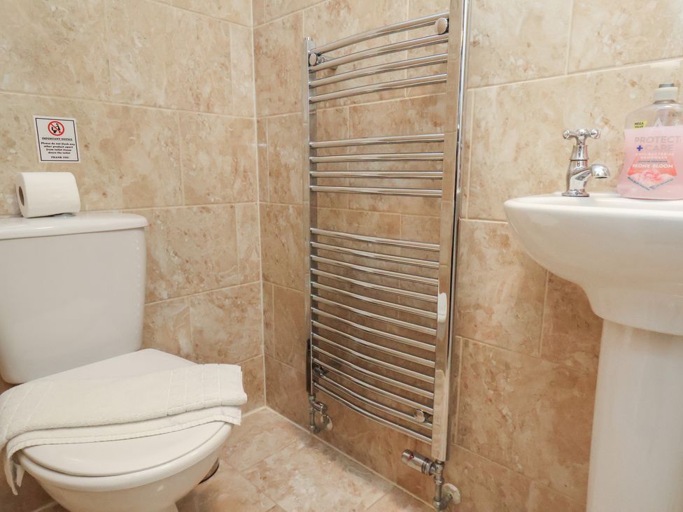 A bathroom with a toilet and sink at Honeysuckle in Filey